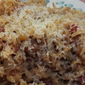 Image from Jayne's Baby Bank (main page), 22 Sep 2025: Dan cooked again. Food waste pasta from the church. Tomatoes, onion , pasta , dented tin of Tomatoes and their cheese, and a tin of♻️🍼👍 cant